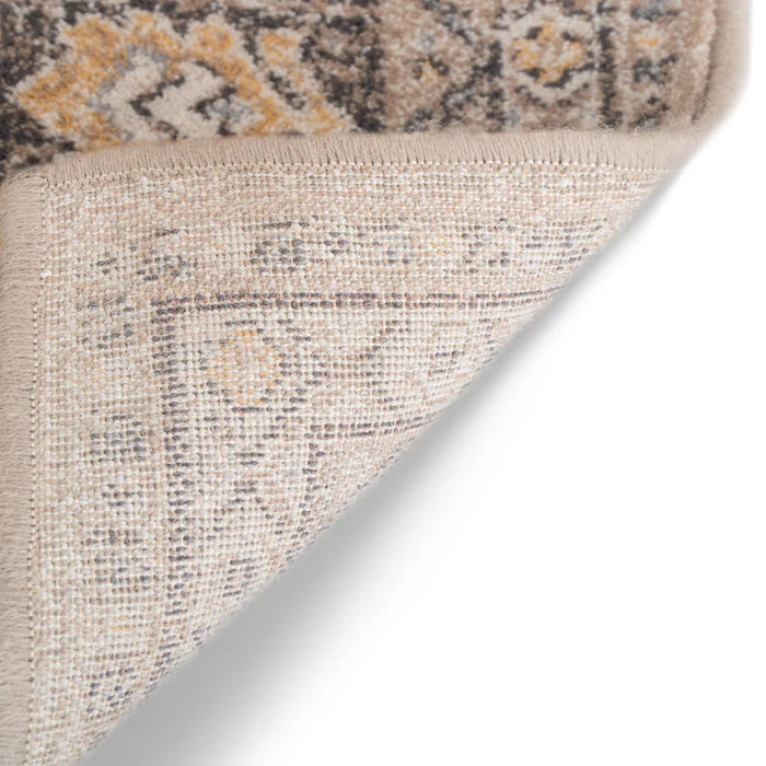 Upturned corner of Acadia Collection area rug, made with wool, vintage details, in neutral tones