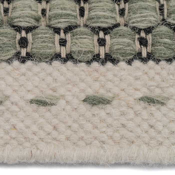 Close up of edging on the Alpine Collection Green area rug