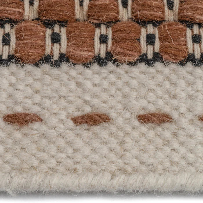 Detailed edging on area rug from Alpine Collection Rust